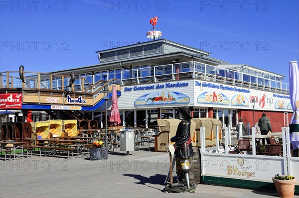List, harbour, Sylt, North Frisian island, Sunny terrace of a restaurant by the sea with colourful signs and empty seats, Sylt, Schleswig-Holstein, Germany, Europe