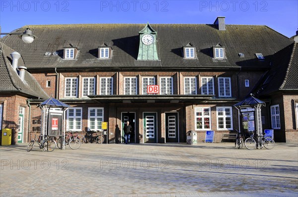 Station building, Westerland station, North Sea island of Sylt, North Frisia, Schleswig-Holstein, brick station with clock, sunshine, people and bicycles in front of the building, Sylt, North Frisian island, Schleswig Holstein, Germany, Europe
