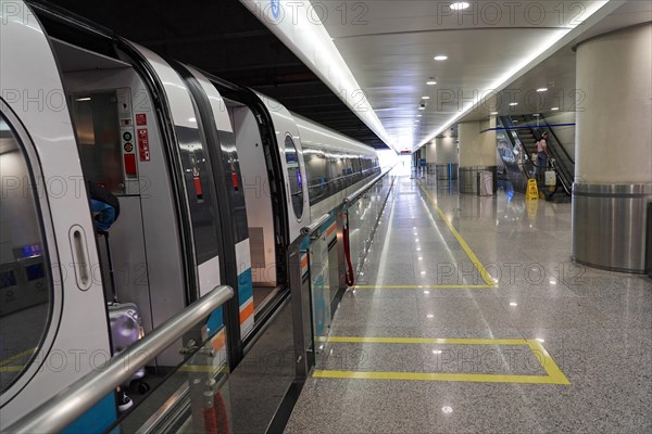 Shanghai Transrapid Maglev Shanghai Maglev Train Station Station, Shanghai, China, Asia, Modern metro station with a train on the platform and striking floor and ceiling lighting, Asia