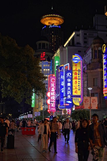 Evening stroll through Shanghai to the sights, Shanghai, Lively street scene at night with illuminated advertising and architecture, Shanghai, People's Republic of China