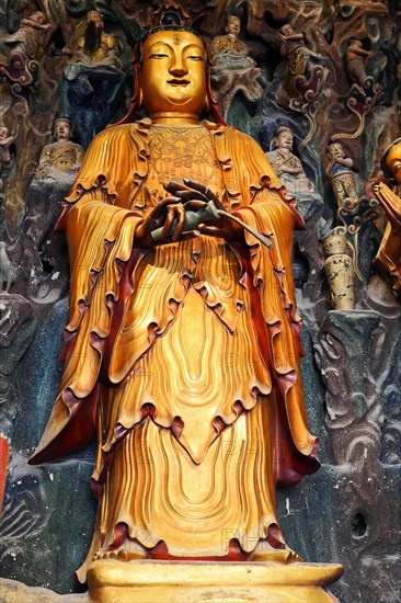 Jade Buddha Temple, Buddha, Puxi, Shanghai, Shanghai Shi, China, Detailed golden Buddha sculpture in front of a complex relief background, Shanghai, People's Republic of China, Asia