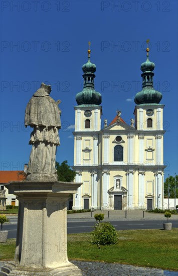 Double-tower facade of the Basilica of the Nativity of the Virgin Mary with Marian column, Roman Catholic pilgrimage church in the town of Frauenkirchen, Seewinkel, Burgenland, Austria, Europe