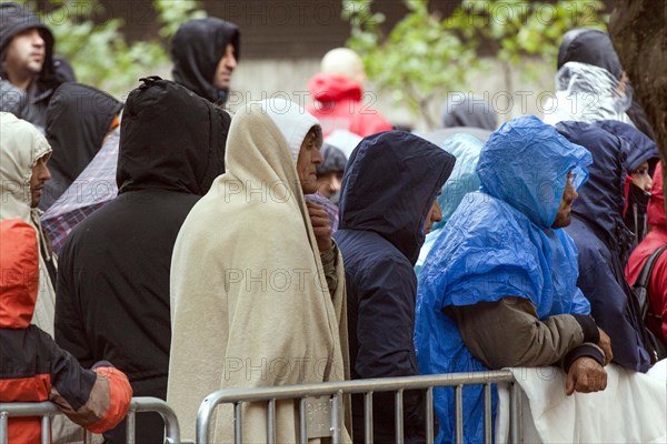 Syrian refugees wait for their registration in cold and wet weather at the Berlin State Office for Health and Social Affairs, 15 October 2015, Berlin, Berlin, Germany, Europe