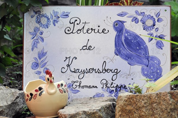 Kaysersberg, Alsace Wine Route, Alsace, Departement Haut-Rhin, France, Europe, A ceramic sign for pottery de Kaysersberg with a bird and floral pattern, Europe