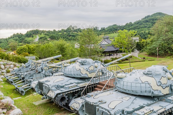 Closeup of military tanks with camouflage paint on display in public park in Nonsan, South Korea on overcast day