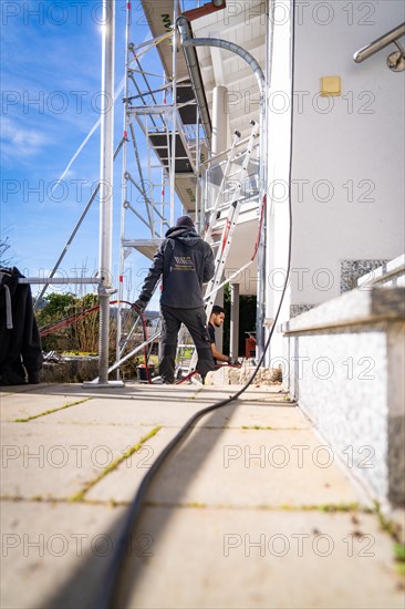 Person walking along a scaffold, cables lying on the ground, solar systems construction, trade, Muehlacker, Enzkreis, Germany, Europe