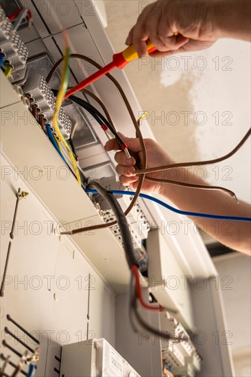 An electrician works carefully on a fuse box, Solar systems construction, Craft, Muehlacker, Enzkreis, Germany, Europe