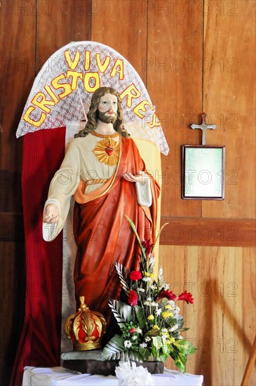 Church of San Juan del Sur, Nicaragua, Central America, Statue of Jesus Christ with his heart on display, surrounded by flowers, Central America