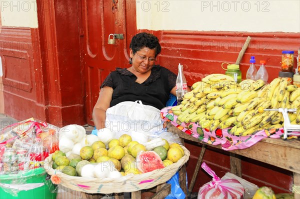 Granada, Nicaragua, A woman sells fruit at a stall on the street under a shady roof, Central America, Central America -, Central America