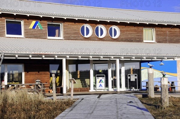 Youth hostel, Beach at Dikjen Deel, Colourful building with various signs and clear sky above, Sylt, North Frisian Island, Schleswig-Holstein, Germany, Europe