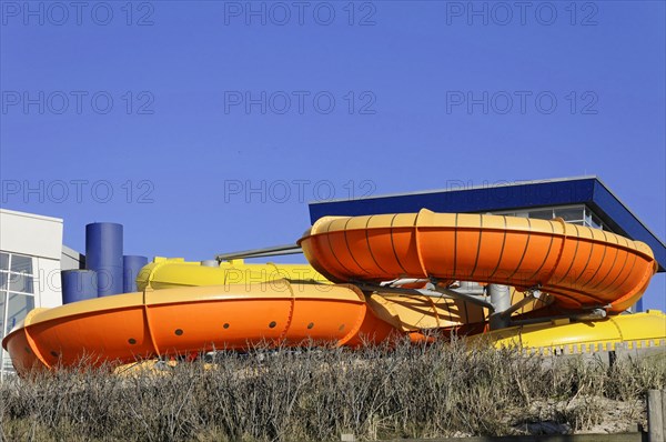 Westerland, Sylt, Schleswig-Holstein, Germany, Europe, Large orange-yellow outdoor water slides in front of a blue sky, North Frisian Island, Schleswig Holstein, Europe