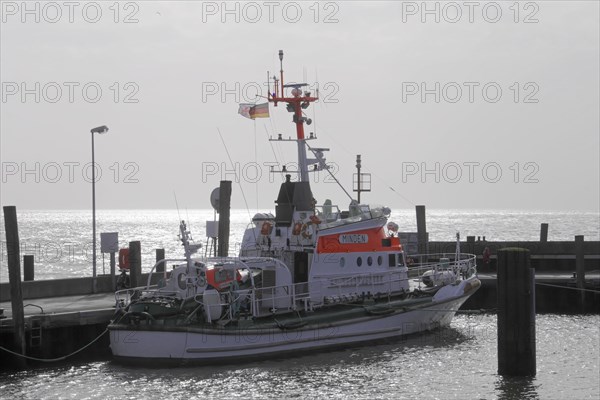 Harbour of List, North Sea island of Sylt, North Frisia, Schleswig-Holstein, lifeboat on a jetty in calm water on a cloudy day, Sylt, North Frisian island, Schleswig Holstein, Germany, Europe