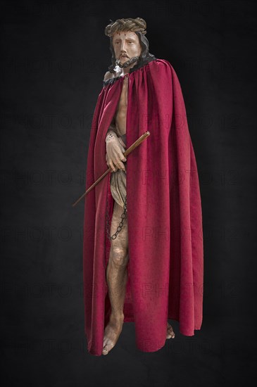 Life-size, carved figure of Jesus with a red cloak on a dark background, 350-year-old processional figure in St Michael's Church, Neunkirchen am Brand, Middle Franconia, Bavaria, Germany, Europe