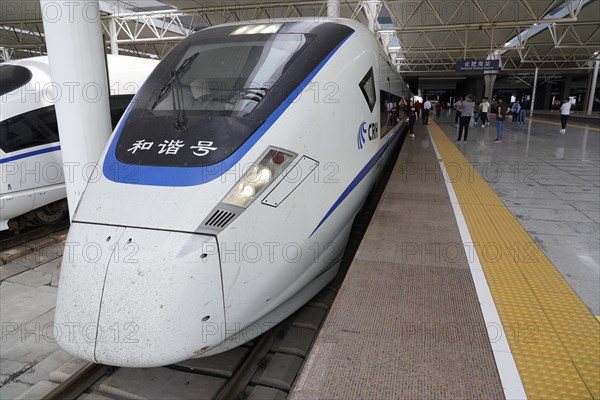 Express train CRH380 to Yichang, A high-speed train waits at a platform with passing passengers, Shanghai, Yichang, Yichang, Hubei Province, China, Asia