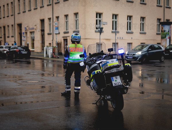 Policewoman with motorbike blocks road, taken during a demonstration in Berlin, 19/04/2024