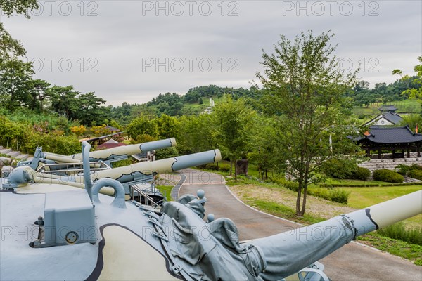 Side view of gun barrels on camouflaged military tanks on display in public park in Nonsan, South Korea, Asia