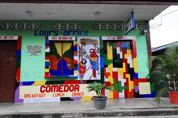 Ometepe Island, Nicaragua, Painted wall of a tourist office with tropical motifs and colourful parrots, Central America, Central America