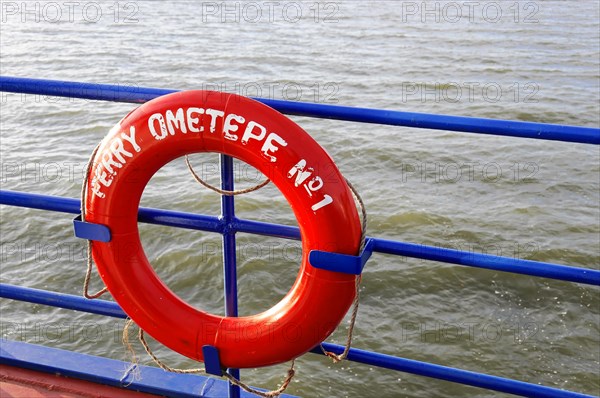Lake Nicaragua, Ometepe Island in the background, Red lifebuoy on board a ferry with the lettering 'FERRY OMETEPE No. 1' and water in the background, Nicaragua, Central America, Central America