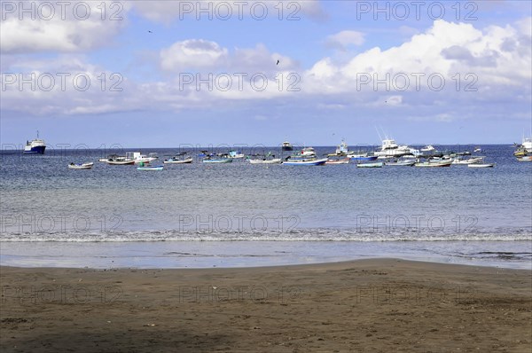 San Juan del Sur, Nicaragua, A group of boats on a calm sea in front of a beach under a cloudy sky, Central America, Central America