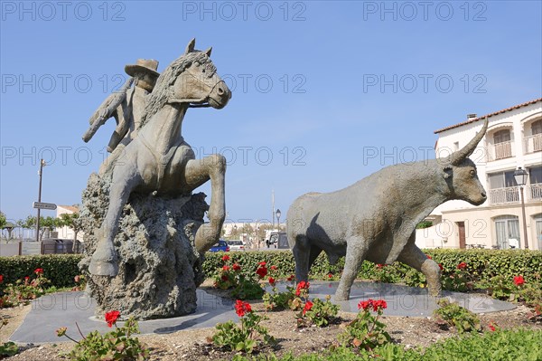 Statue of a drover with Camargue horse and Camargue bull, Les Saintes-Maries-de-la-Mer, Camargue, Bouches-du-Rhone, Provence-Alpes-Cote d'Azur, South of France, France, Europe