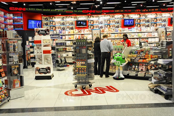AUGUSTO C. SANDINO Airport, Managua, Nicaragua, Customers in a magazine shop at the airport with the CNN logo on the floor, Central America, Central America