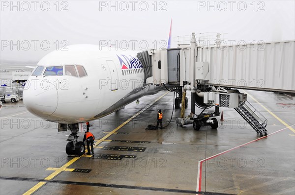 AUGUSTO C. SANDINO Airport, Managua, Nicaragua, An aircraft at the gate with jet bridge extended and ground crew nearby, Central America, Central America