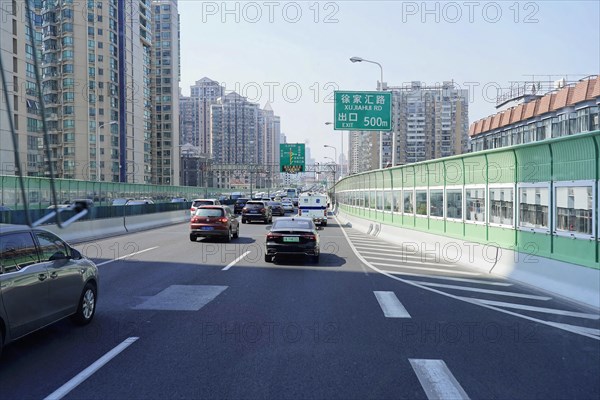 Traffic in Shanghai, Shanghai Shi, vehicles on an urban street with high-rise buildings and traffic signs, Shanghai, People's Republic of China