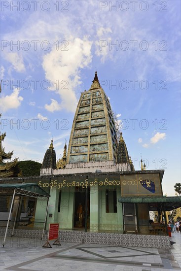 Shwedagon Pagoda, Yangon, Myanmar, Asia, The facade of a pagoda with intricate, ornate decorations and figures, Asia
