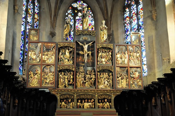 Kaysersberg, Alsace Wine Route, Alsace, Departement Haut-Rhin, France, Europe, Detailed wood carved altar with reliefs and a stained glass window behind it, Europe