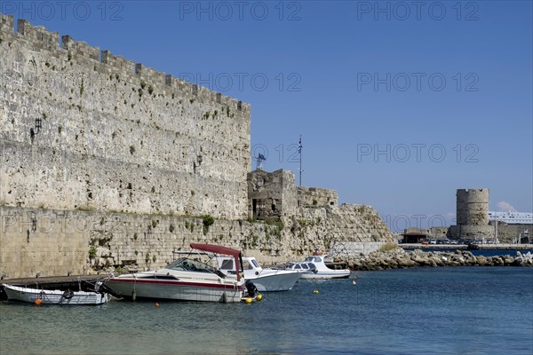 Boats anchoring in Kolona harbour in front of the city wall, Rhodes, Dodecanese archipelago, Greek islands, Greece, Europe