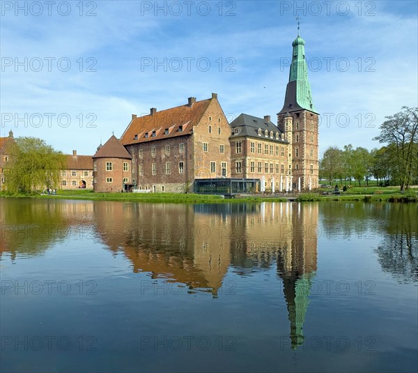 View over moat to historic moated castle from Renaissance Raesfeld Castle reflected in moat in spring, excursion destination in North Rhine-Westphalia, Freiheit Raesfeld, Muensterland, North Rhine-Westphalia, Germany, Europe