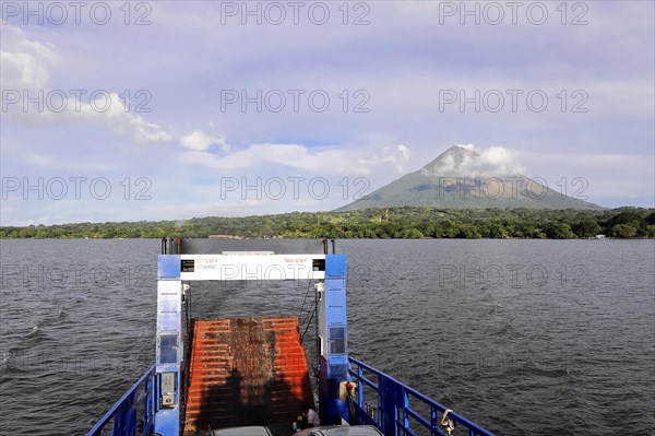 Lake Nicaragua, behind the island of Ometepe, view from the stern ferry onto a lake with a volcano in the background under a partly cloudy sky, Nicaragua, Central America, Central America