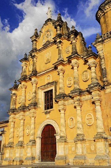 Church La Recoleccion, 1786, Leon, Nicaragua, Baroque church facade in warm sunlight, Baroque church with yellow facade under a dramatic sky with clouds, Central America, Central America