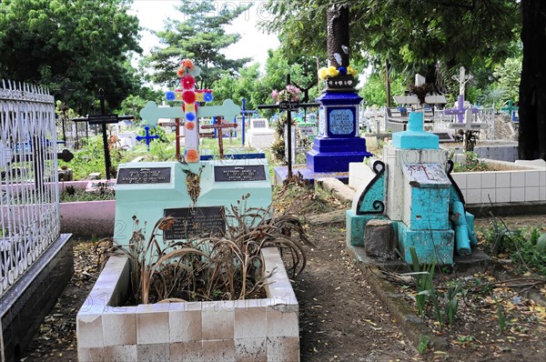 Leon, Nicaragua, A cemetery with colourful crosses and graves surrounded by vegetation, Central America, Central America