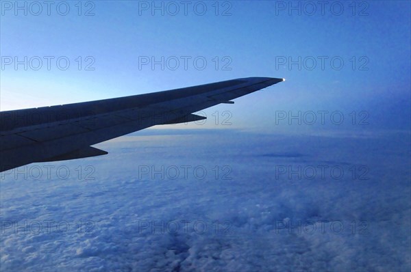 Flight to Stuttgart, Germany, view of an aeroplane wing above the clouds at dusk, AUGUSTO C. SANDINO Airport, Managua, Nicaragua, Central America, Central America