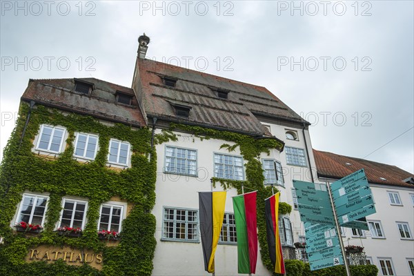 Historic town hall from the 15th century with many signposts in front of it, Isny im Allgaeu, Baden-Wuerttemberg, Germany, Europe