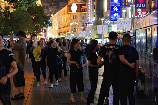 Shanghai at night, China, Asia, Urban scene at night with a crowd of people and shops in the background, Shanghai, Asia