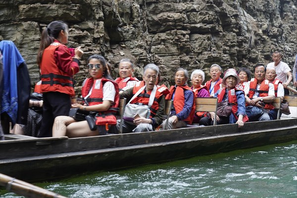 Special boats for the side arms of the Yangtze, for the tourists of the river cruise ships, Yichang, China, Asia, People in orange life jackets sitting in a boat, Hubei province, Asia