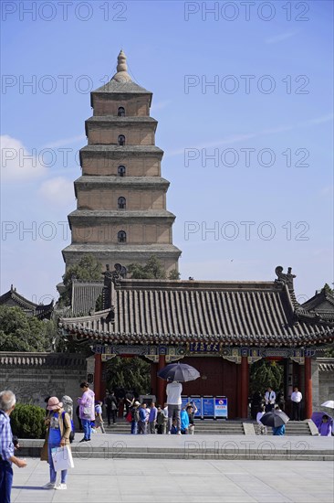 Traditional Chinese pagoda under a clear blue sky with visitors in front of it, Chongqing, Chongqing, Chongqing Province, China, Asia