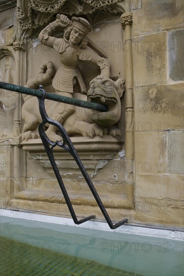 Dragon slayer motif on the fish fountain, dragon, sword, fountain, market fountain, old town, market square, Schwaebisch Hall, Hohenlohe, Heilbronn-Franken, Baden-Wuerttemberg, Germany, Europe