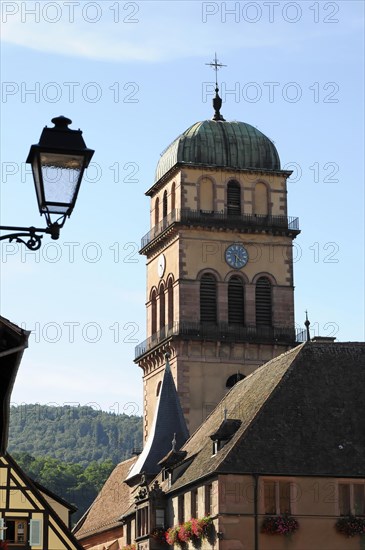 Kaysersberg, Alsace Wine Route, Alsace, Departement Haut-Rhin, France, Europe, Church tower with clock stands prominently in front of a clear blue sky, Europe