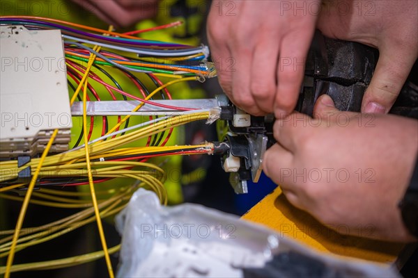 Close-up of an electrician's hands working on a complex wiring harness, Galsfaserbau, Calw, Black Forest, Germany, Europe