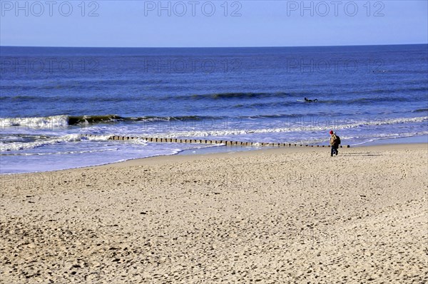 Westerland, Sylt, Schleswig-Holstein, Germany, Europe, Person walking along the edge of the sea along an extensive sandy beach, North Frisian Island, Schleswig Holstein, Europe
