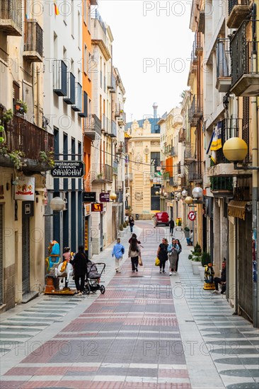 Narrow streets with shops in the city centre of Figueras, Spain, Europe