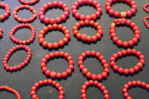 Chongqing, Chongqing Province, China, Asia, Collection of red handmade bracelets on a dark background, Asia