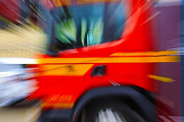 Focussed on the tyre, the image shows a fast-moving fire engine