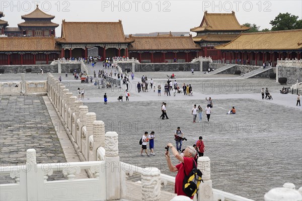China, Beijing, Forbidden City, UNESCO World Heritage Site, view of visitors walking along the ancient walls and buildings of the Forbidden City, Asia