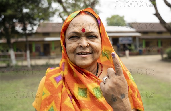 BOKAKHAT, INDIA, APRIL 19: A women show her marked finger after casting vote during the first phase of the India's general elections on April 19, 2024 in Bokakhat, Assam, India. Nearly a billion Indians vote to elect a new government in six-week-long parliamentary polls starting today