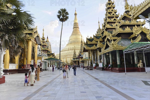 Shwedagon Pagoda, Yangon, Myanmar, Asia, Group of people and tourists in front of an imposing golden pagoda under a blue sky, Asia