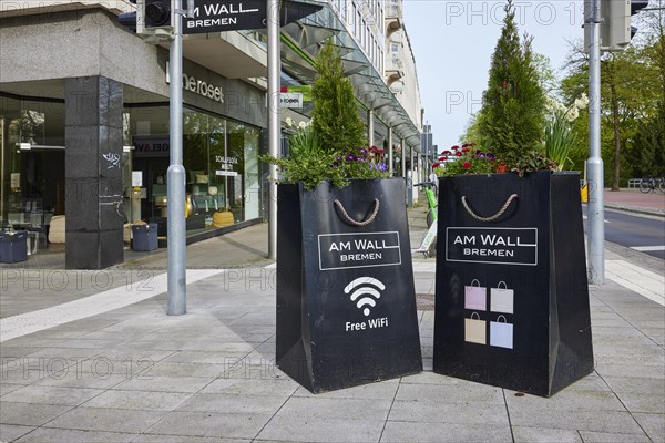 Planters as oversized shopping bags with cord on the Am Wall shopping street in Bremen, Hanseatic city, federal state of Bremen, Germany, Europe